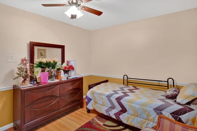 Cozy resident room with decorated dresser and bed