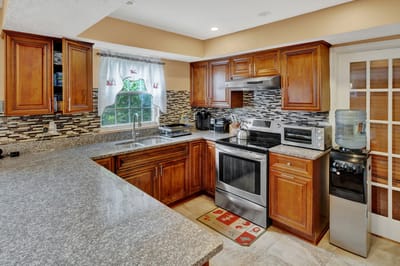 Bright kitchen area with wooden cabinets and modern appliances