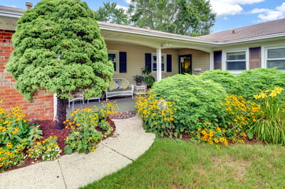 Lush garden and pathway leading to a porch