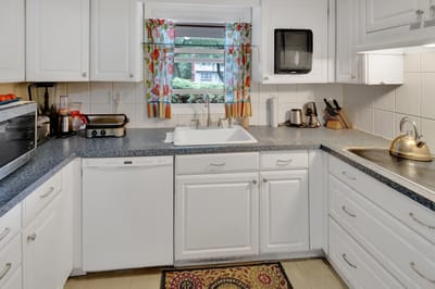 Bright kitchen with floral curtains and modern appliances