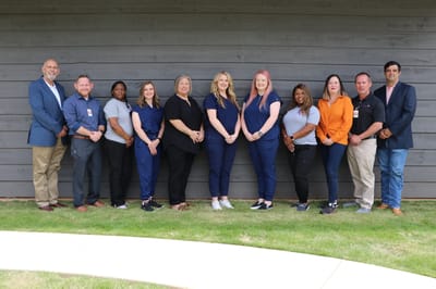 Staff members posing together outdoors
