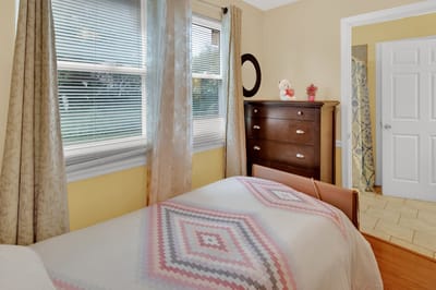 Cozy bedroom with a quilted bed and window.
