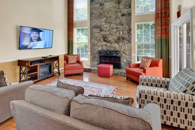 Bright common area with seating and a TV