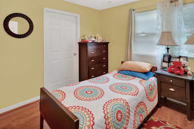Cozy private resident room with colorful bedding