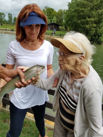 Residents enjoying fishing together by the lake