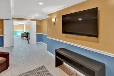 Interior view of a common area with seating and a television