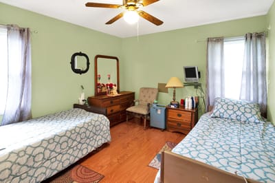 Cozy shared resident room with two beds and furnishings