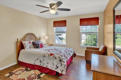 Cozy resident room with floral bedding and natural light