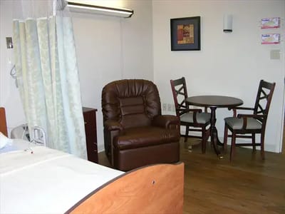 Cozy resident room setup with seating and table
