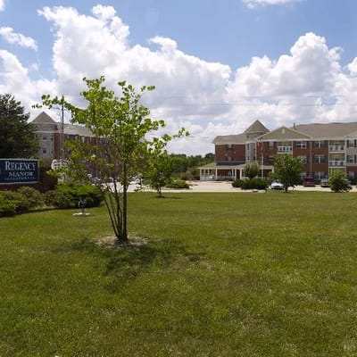 Exterior view of Regency Manor with landscaped grounds