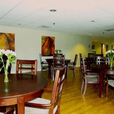 Interior dining area with wooden tables and flowers