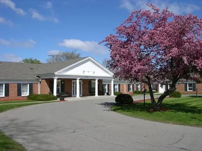 Exterior view of Medilodge with blooming tree