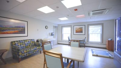 Bright, comfortable common area with seating and paintings