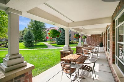 Outdoor patio area with seating and greenery
