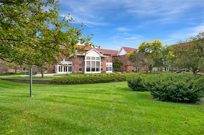 Exterior view of a senior living facility with landscaped grounds