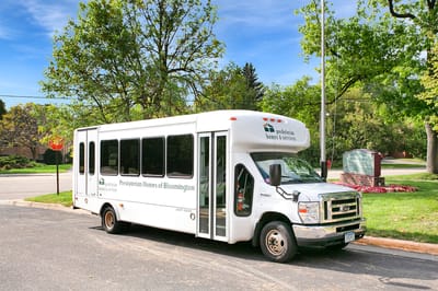 Facility transport shuttle parked outside