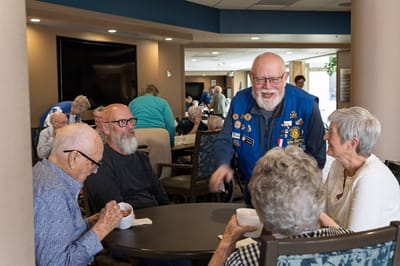 Residents enjoying a lively conversation in a common area