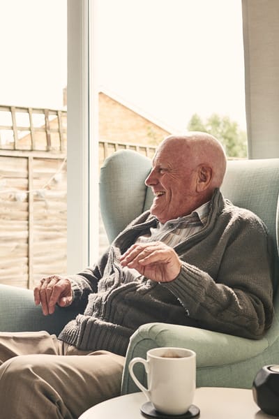 Senior man smiling in a cozy living space