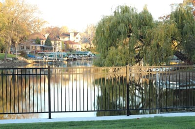 Scenic view of a lake with trees and a fence