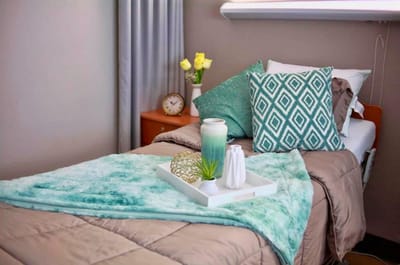 Well-decorated resident bedroom with soft colors