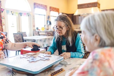 Residents engaged in a board game activity in a common area
