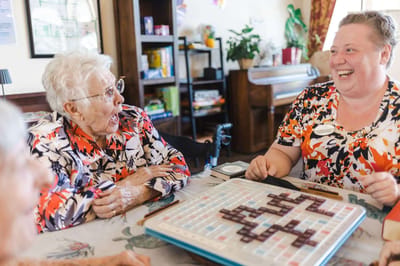 Residents and staff enjoying a game of Scrabble together