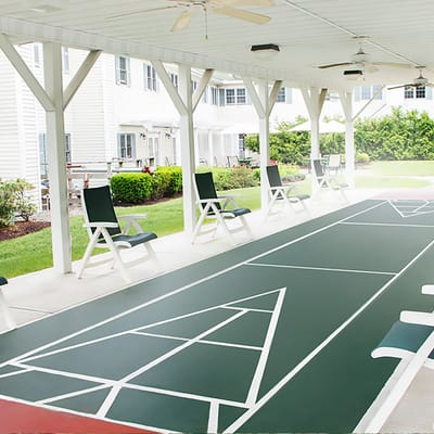 Outdoor shuffleboard area with seating