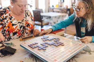 Residents engaging in a game of Scrabble in a common area