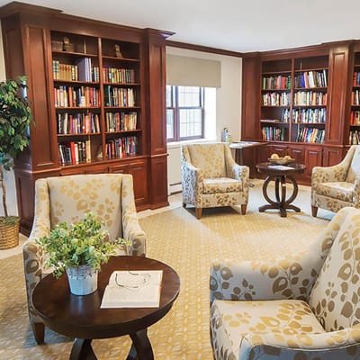 Cozy common area with bookshelves and comfortable chairs