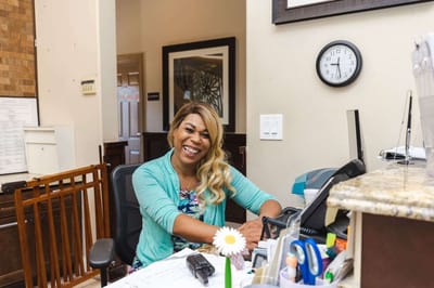 Receptionist smiling at the front desk