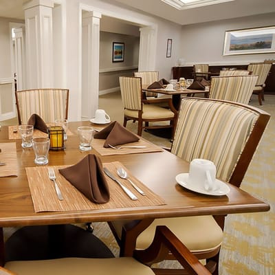 Dining room with neatly set tables and chairs