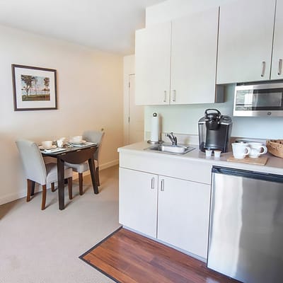Modern kitchenette and dining area in a senior living unit