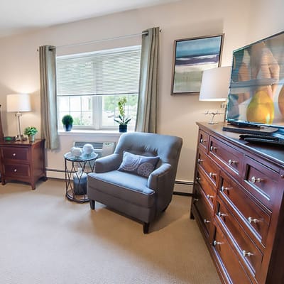 A cozy resident room with seating and decor