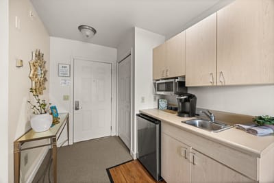 An interior view of a senior living unit kitchen area