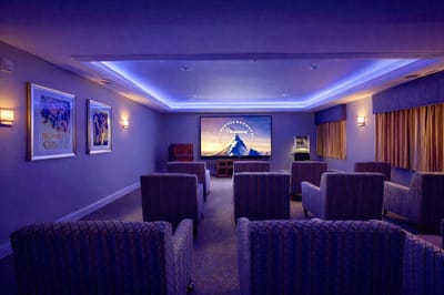 A cozy theater room with seating and a large screen
