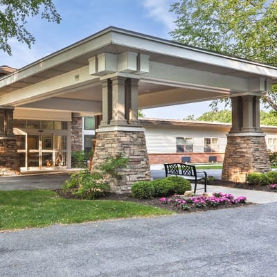 Exterior view of the facility entrance with flower beds