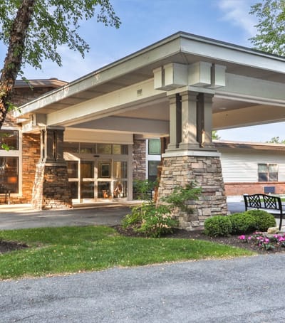 Exterior view of the senior living facility entrance with landscaping
