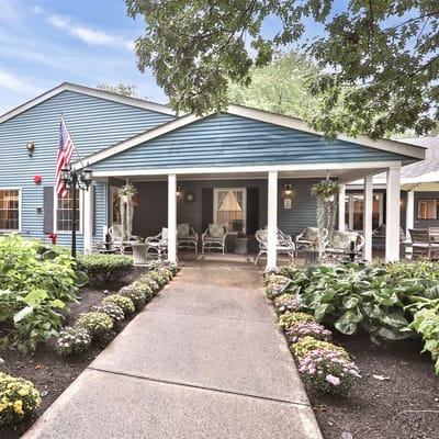 Exterior view of a senior living facility with a garden path