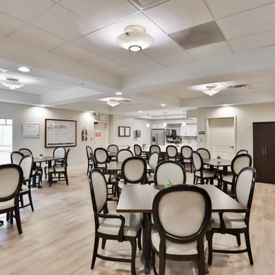 Dining area with tables and chairs set for residents