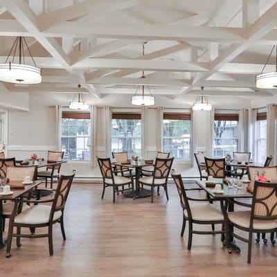 Brightly lit dining area with tables and chairs