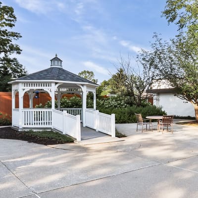 A scenic outdoor gazebo in a landscaped area