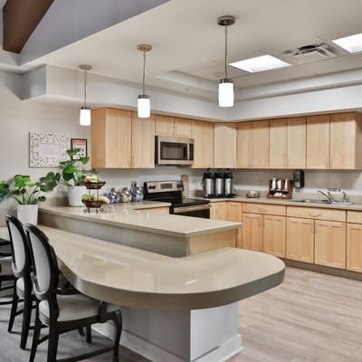 Modern kitchen area with seating and appliances