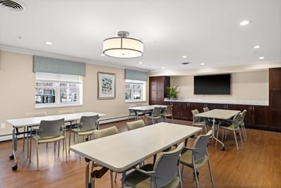 Bright activity room with tables and chairs