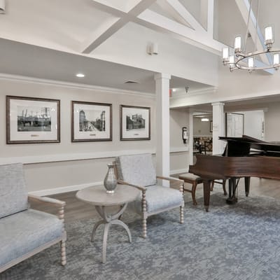 Interior view of a common area with seating and piano