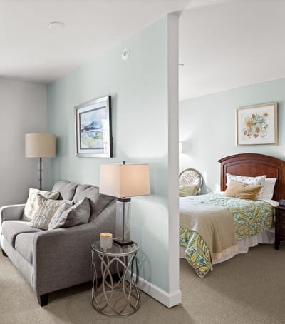 Cozy resident room with a sitting area and bed