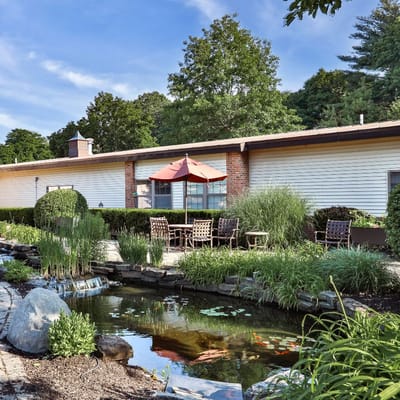 Outdoor area with seating and a pond