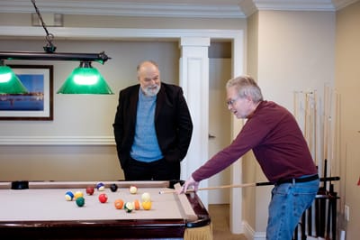 Residents playing billiards in a common area
