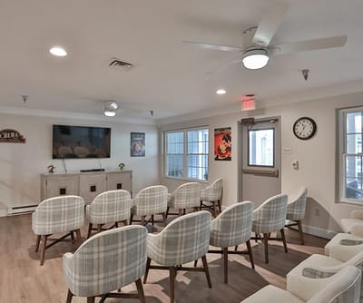 Bright common area with chairs and TV