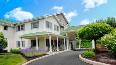 Exterior view of a senior living facility with gardens