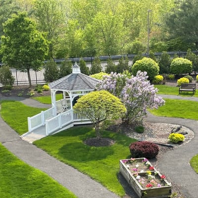 A beautiful outdoor gazebo surrounded by greenery and flowers
